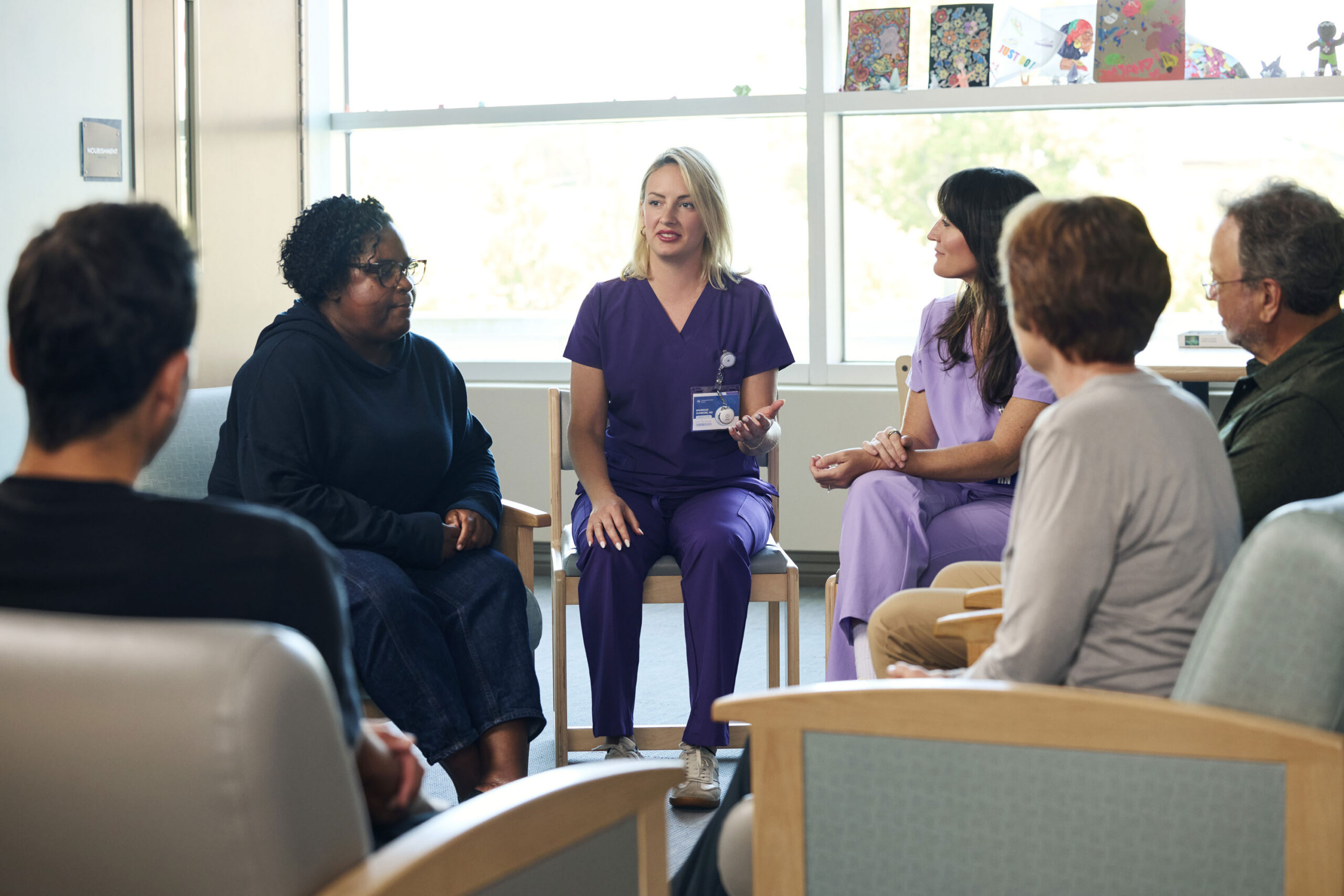 therapist and nurse leading a group therapy session in a behavioral health facility