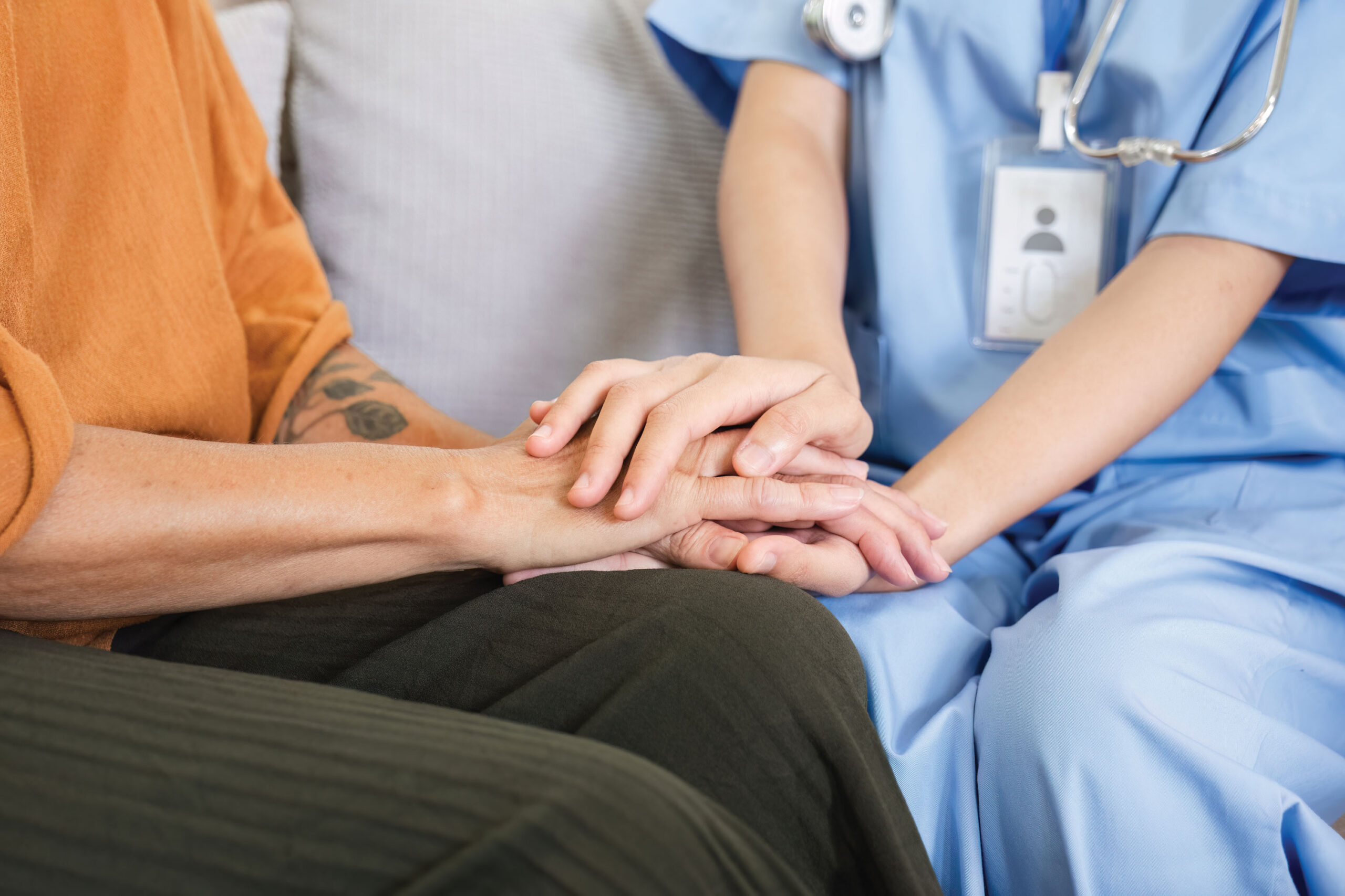 medical professional and patient with hands in lap
